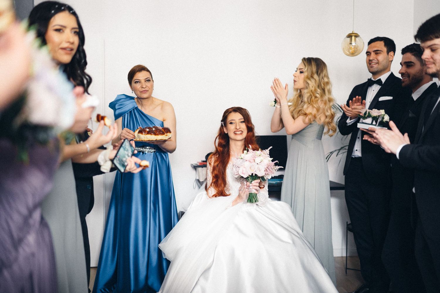 Wedding party gathered in celebration with mix of formal attire in blue, purple and white.