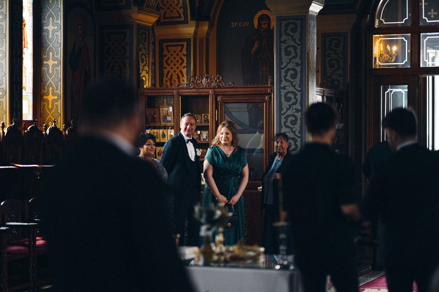Wedding ceremony in an ornate church interior with elaborate decorations and architectural details.