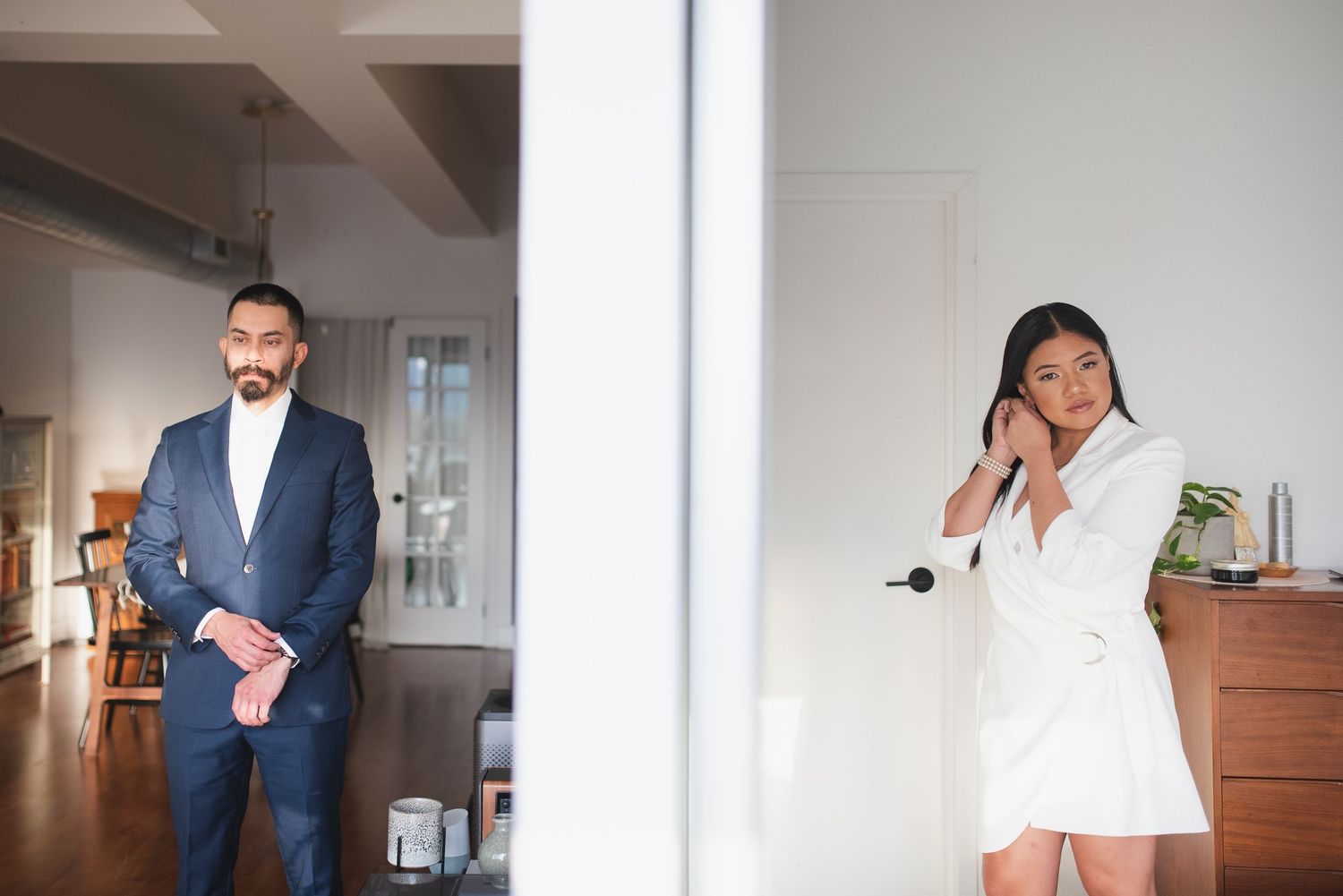 Modern office setting with two people separated by a white wall partition.