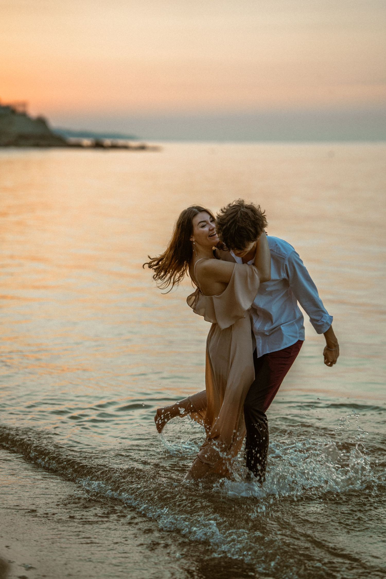 Sunset engagement photo, couple having fun in the water, Branson Missouri engagement session