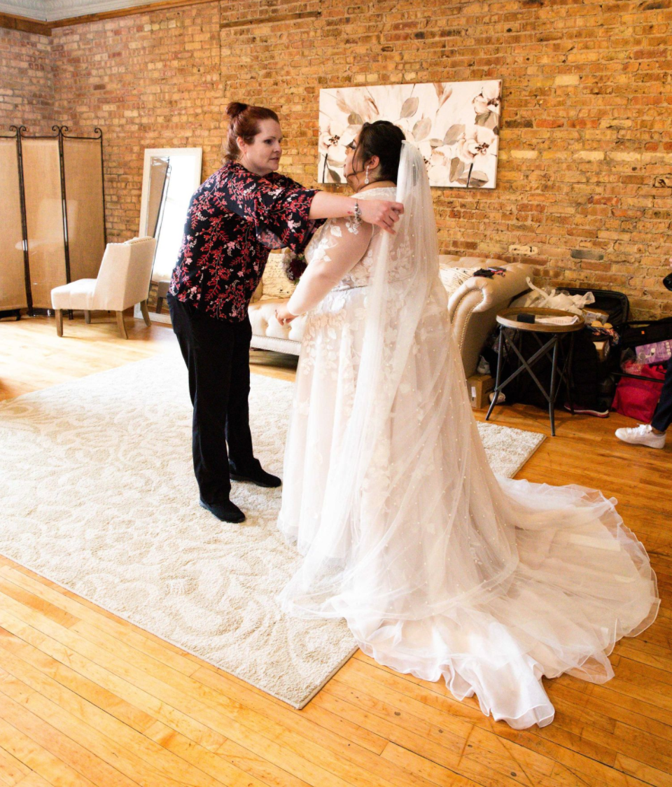 photograph helping bride with veil