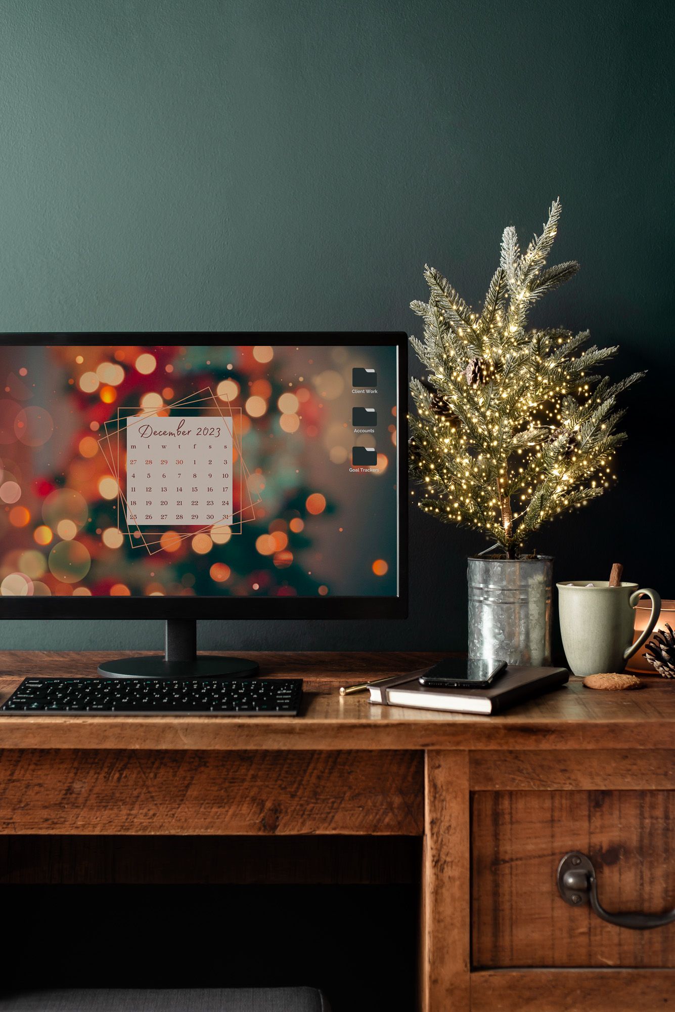 small christmas tree on dark rustic desk with monitor, dark green wall, rustic, cozy, bloggers, seasonal, coaches