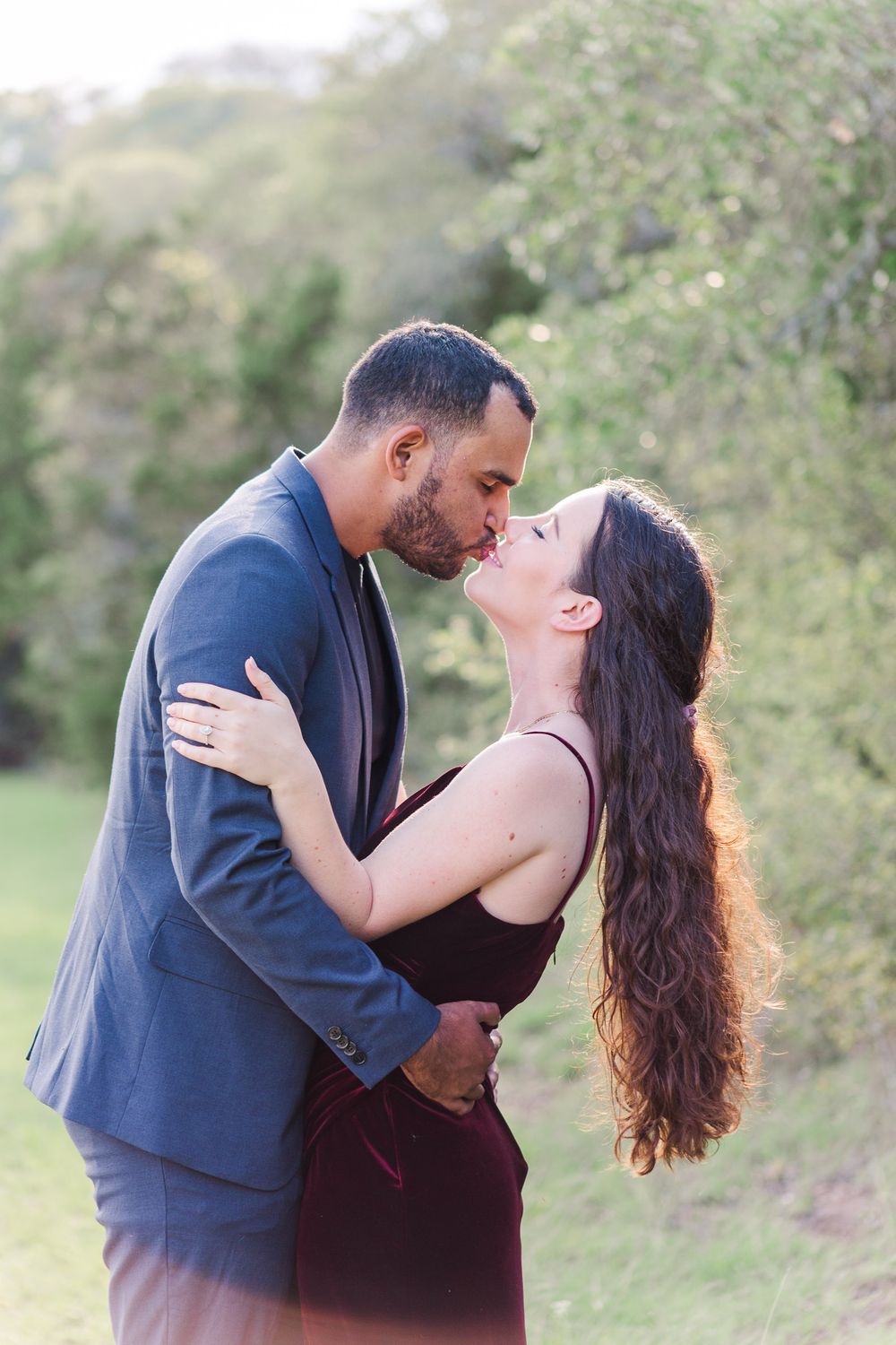Romantic outdoor portrait of couple in elegant attire.