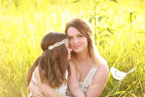 Intimate portrait of two people embracing in golden sunlit field.