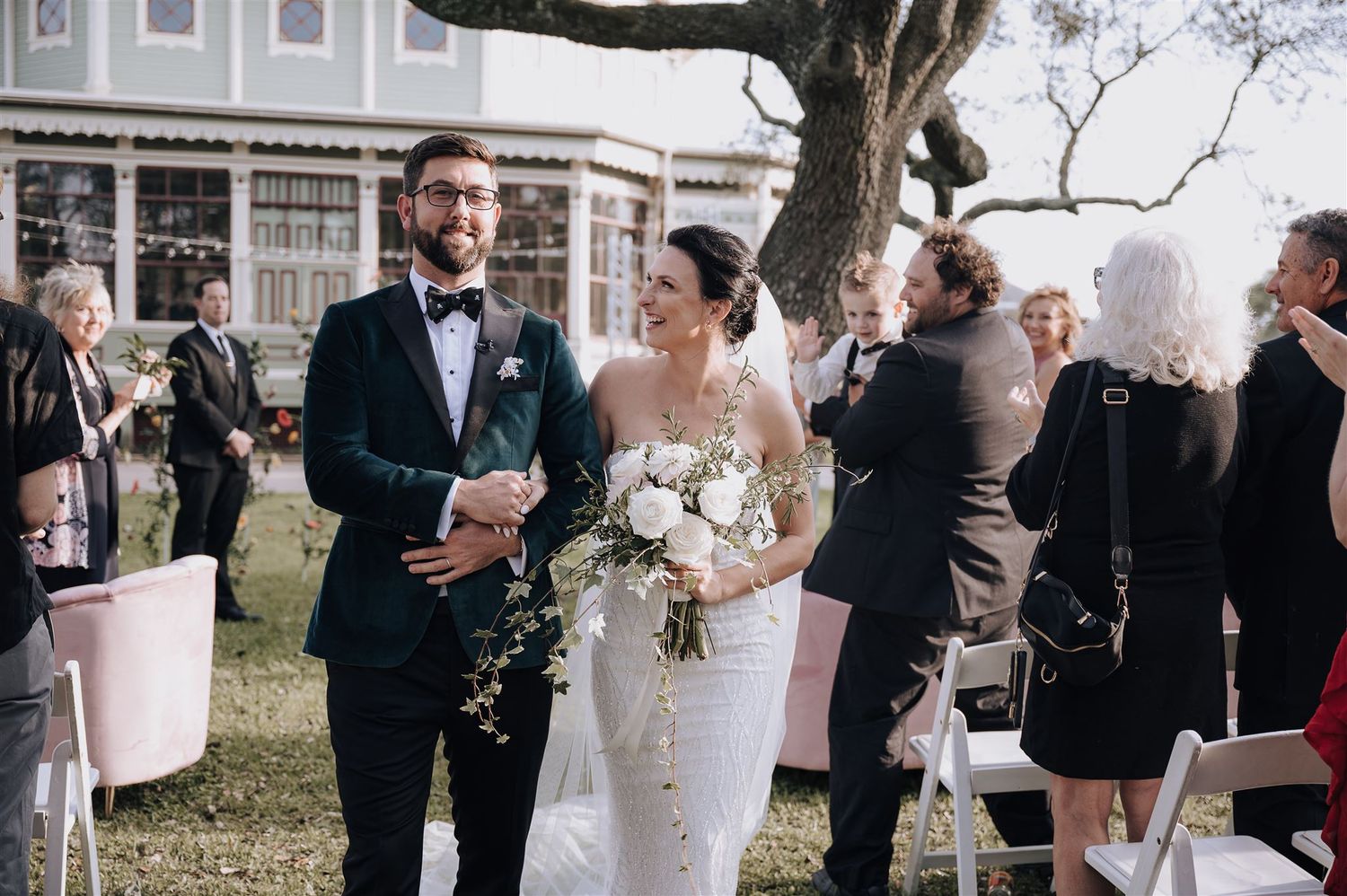Outdoor wedding ceremony setup with bridal bouquet and formal attire.