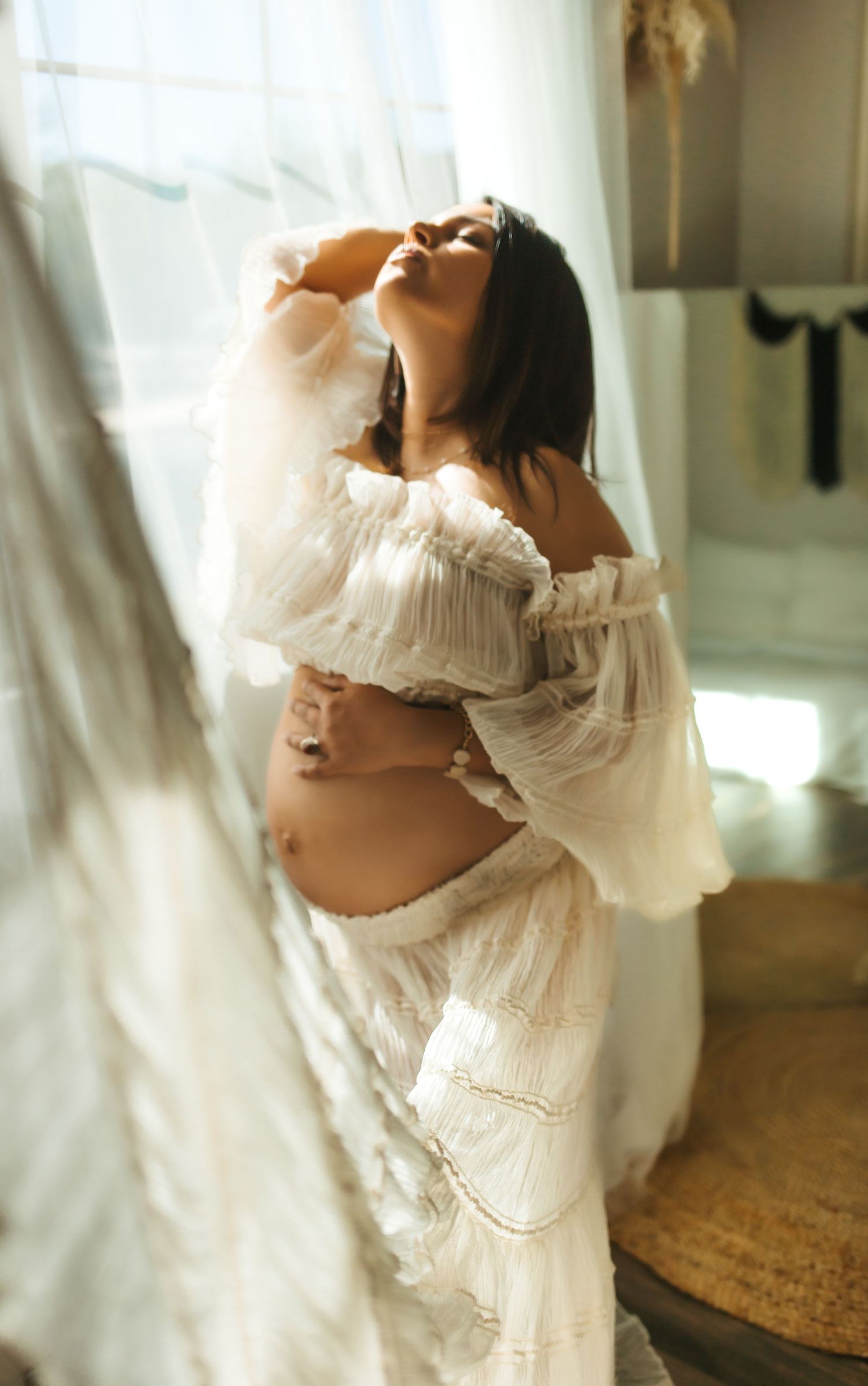 soft lighting motherhood maternity in studio baby bump bare belly