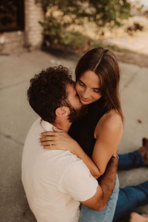 mom and dad get a moment to love on each other during family photography session