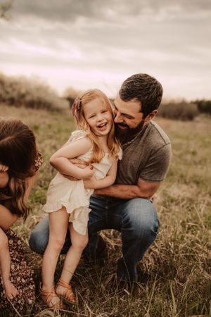 cuddles with dad during family photo session