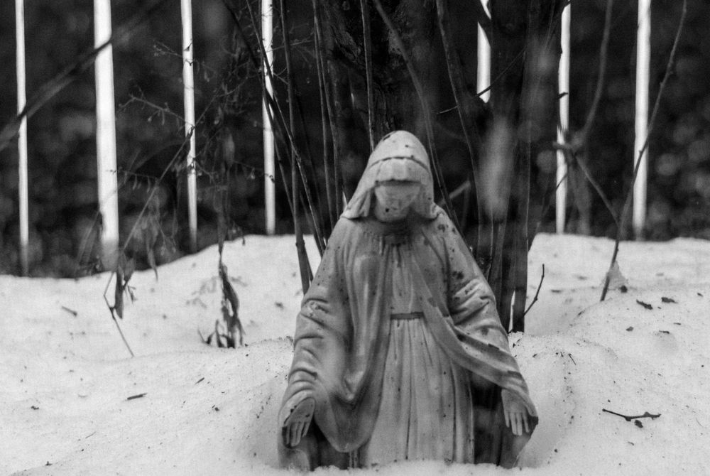 A statue of Mary in the snow