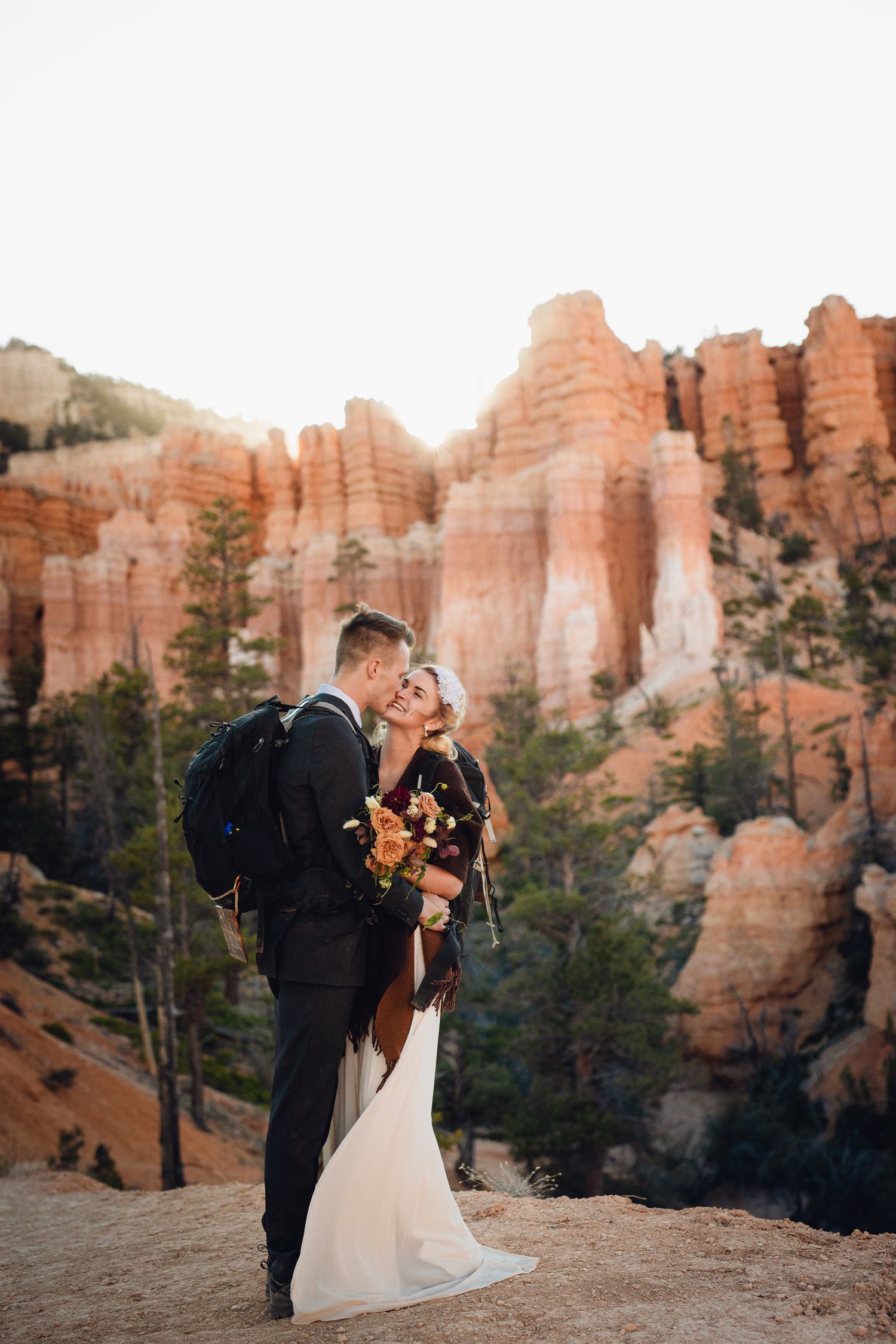Couple kissing at Bryce Canyon National Park after getting married and hiking.
