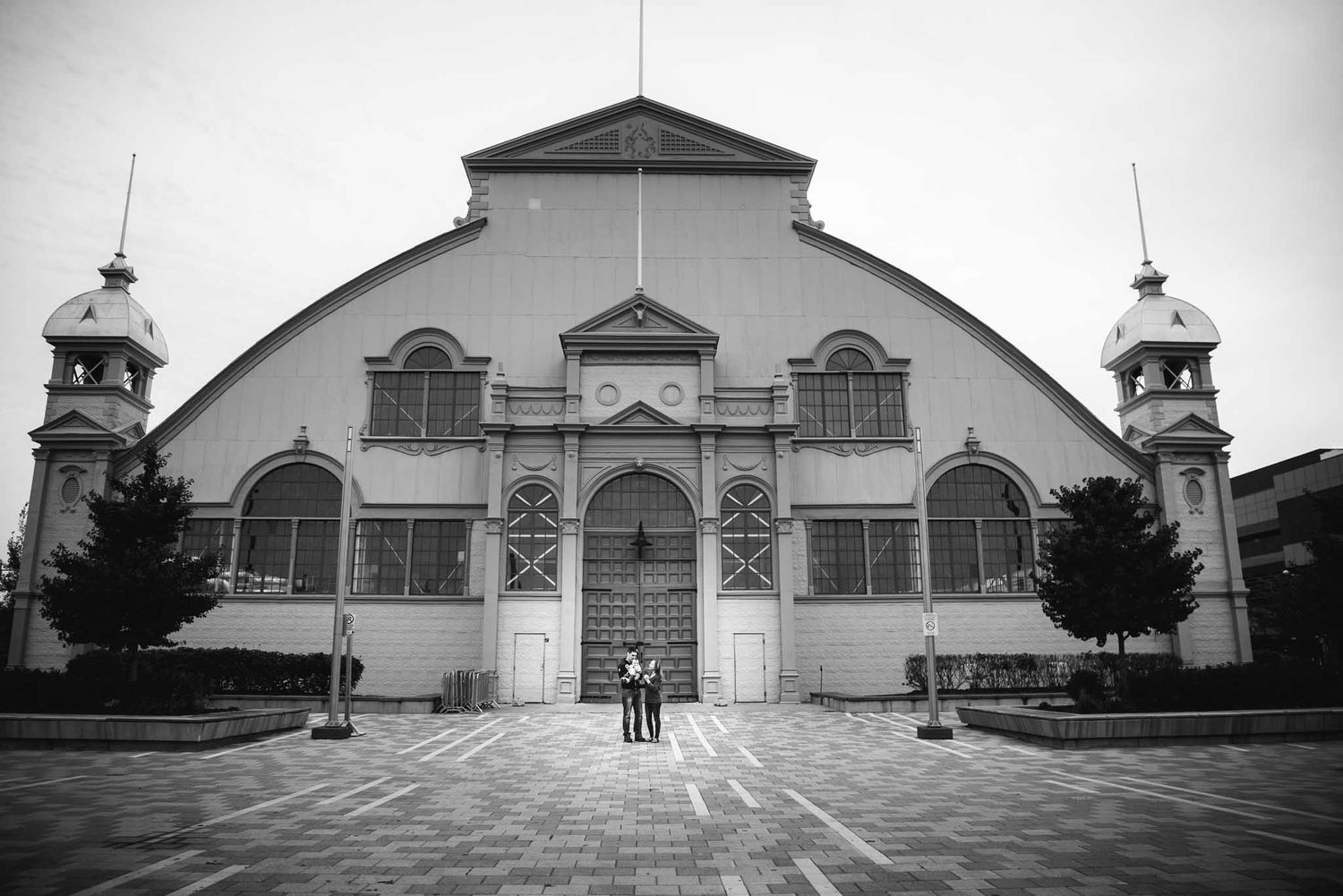 Black and white image taken in front of Lansdown Pavilion with a family standing in front.