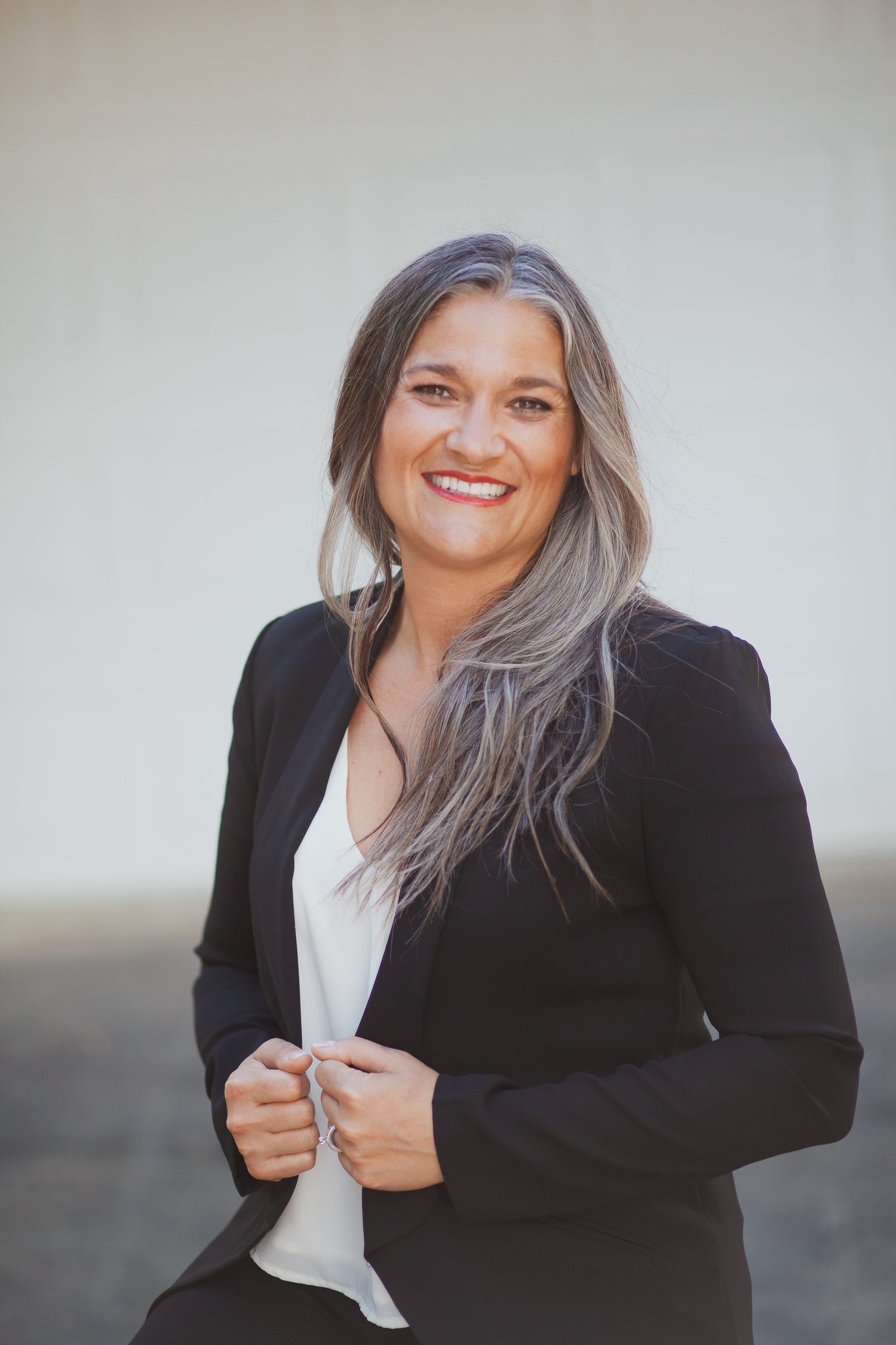 A joyful female entrepreneur shares her creative workspace, filled with social media content ideas for her local busines