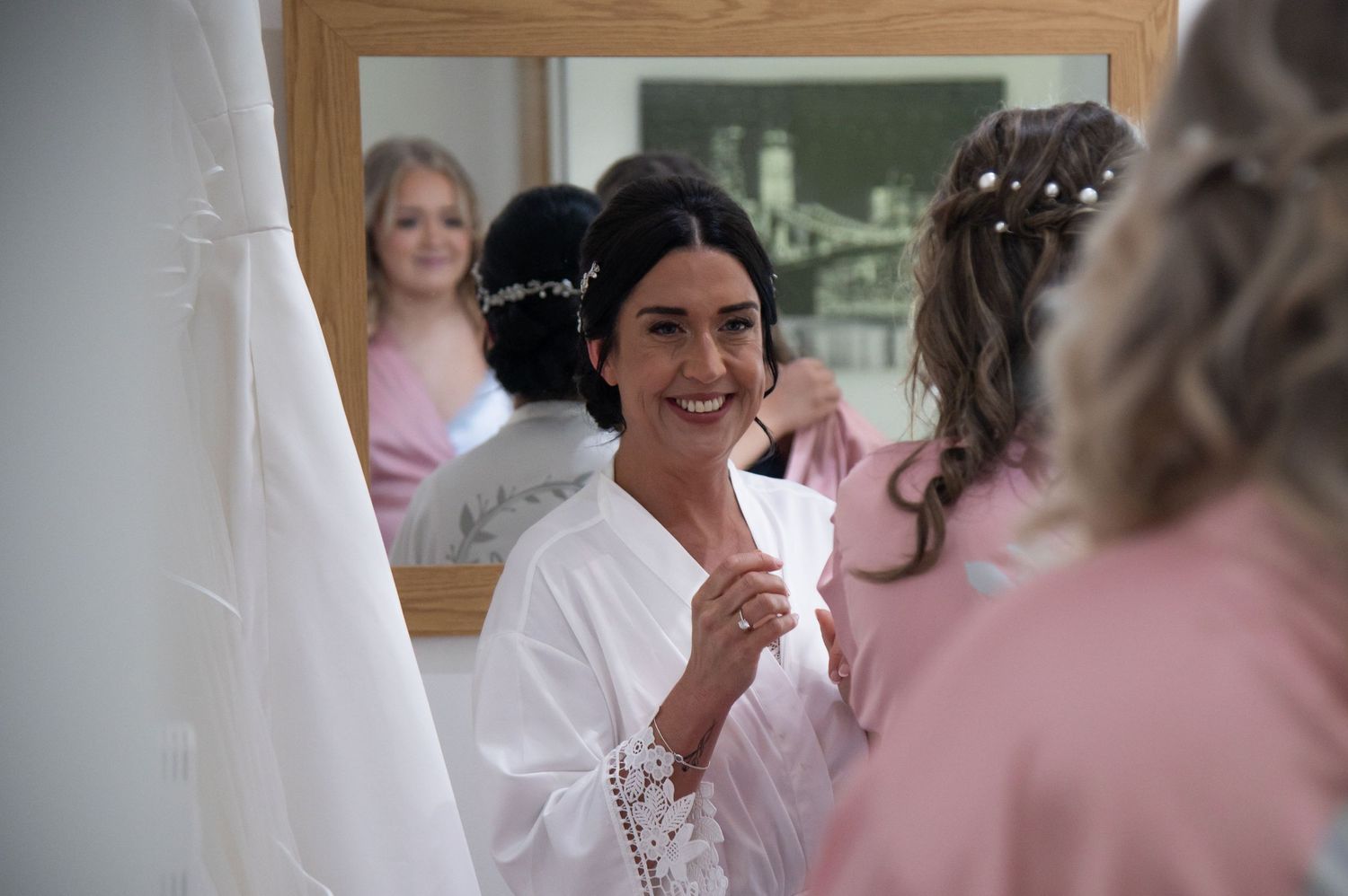 Wedding morning preparations with bridesmaids in pink robes getting ready.