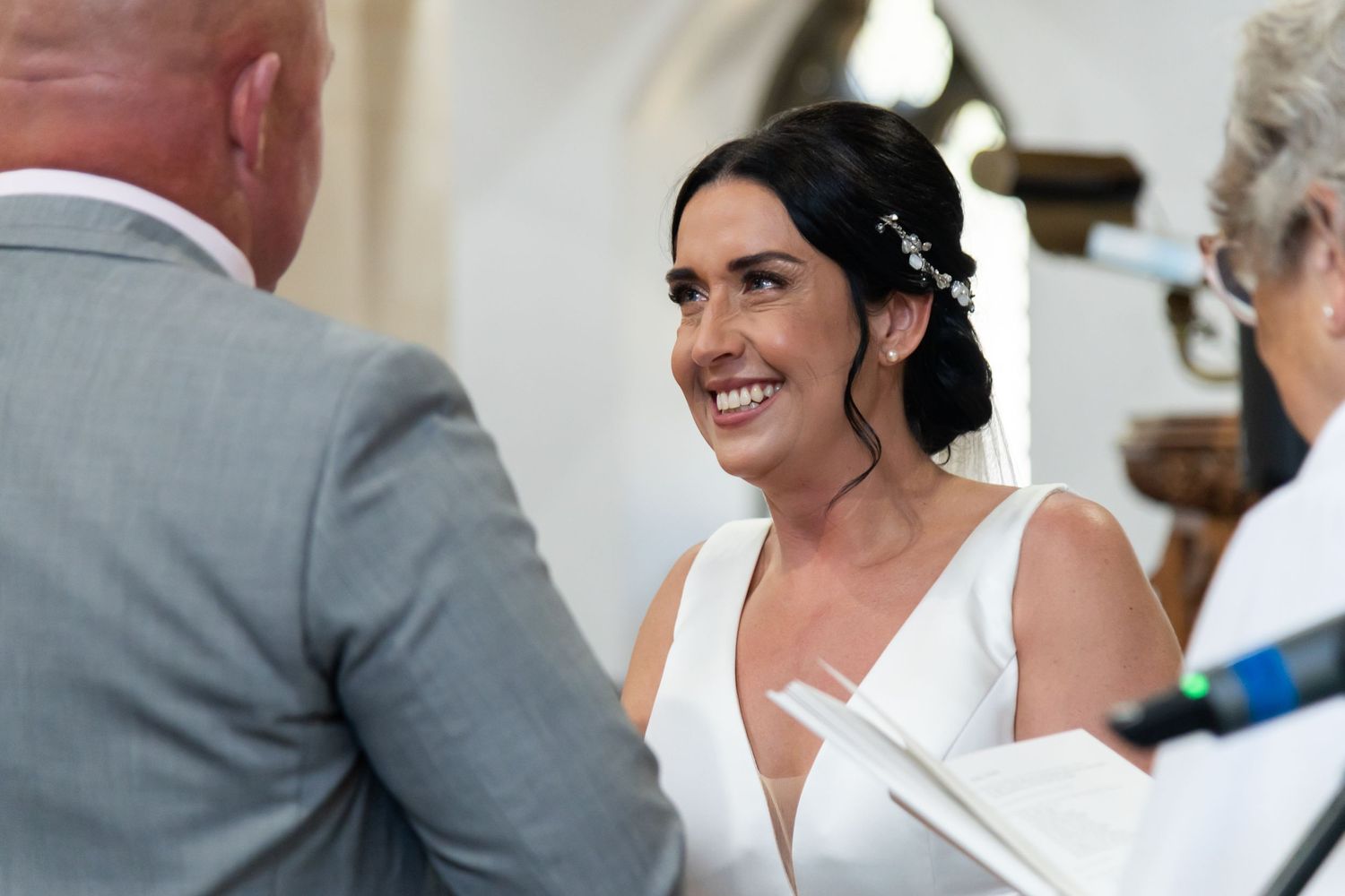 Wedding ceremony candid shots showing emotional reactions in church setting.