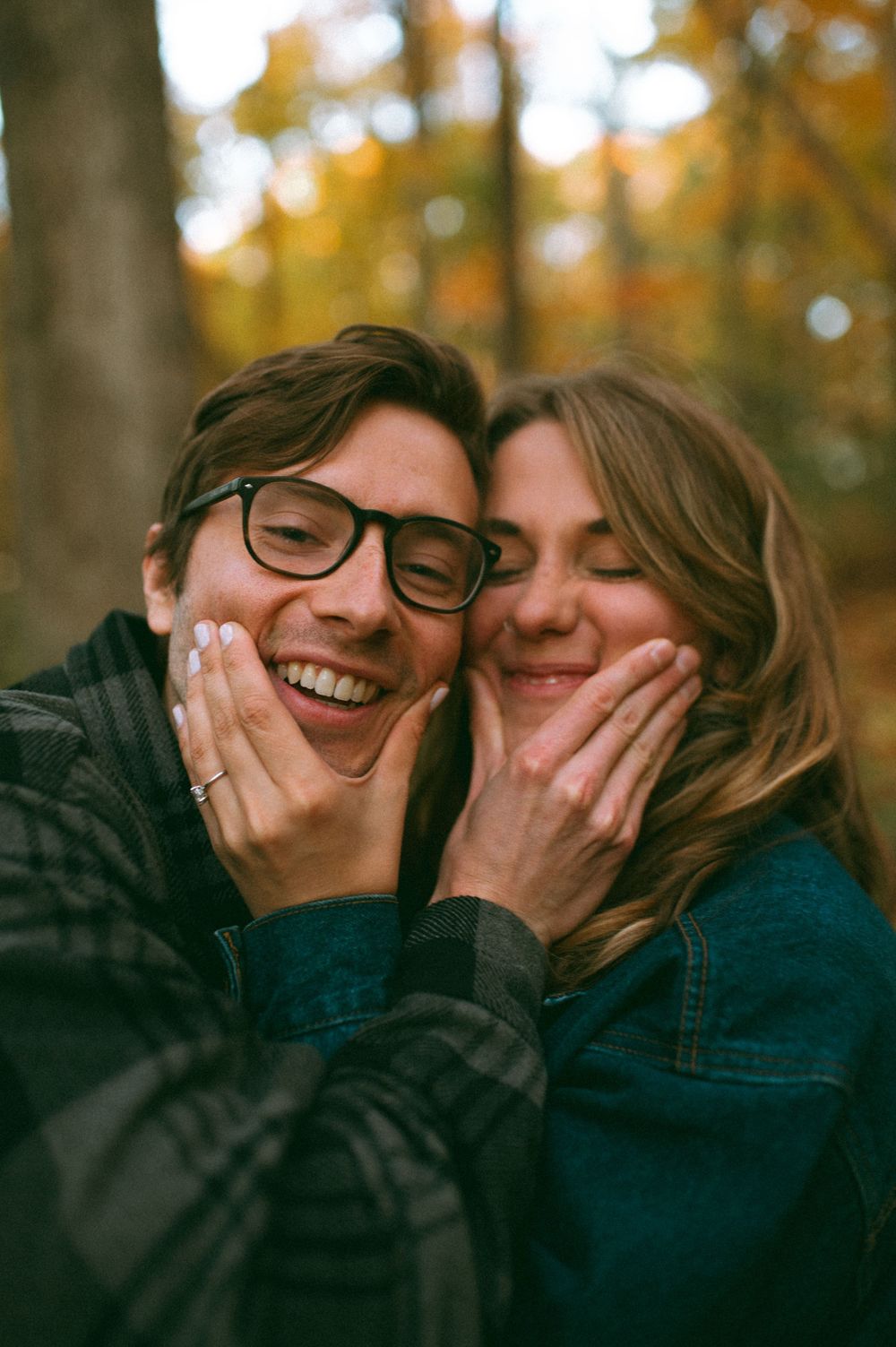 Joyful moment captured in autumn forest with warm golden lighting.