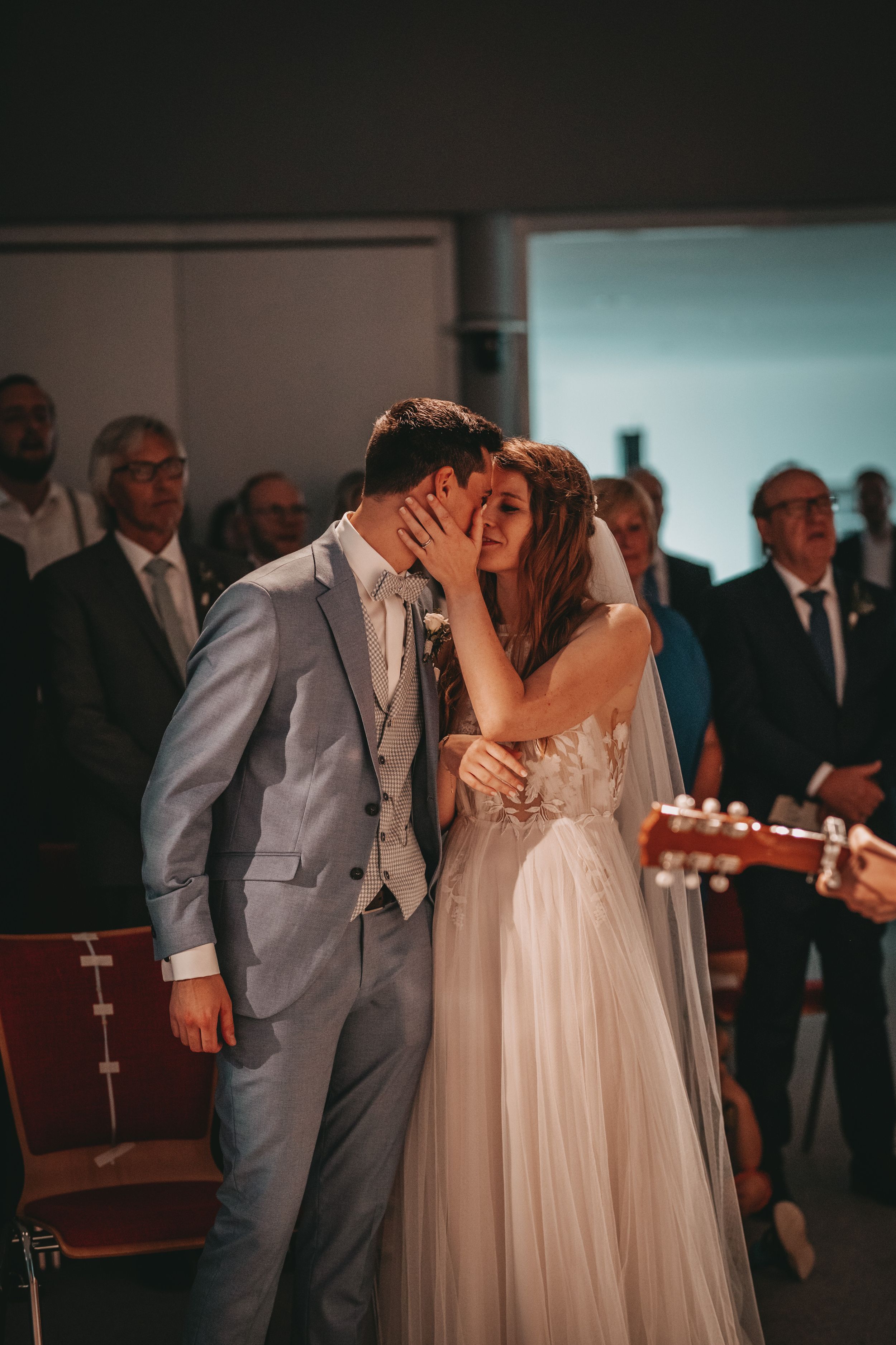 A tender kiss shared between newlyweds during their wedding ceremony.
