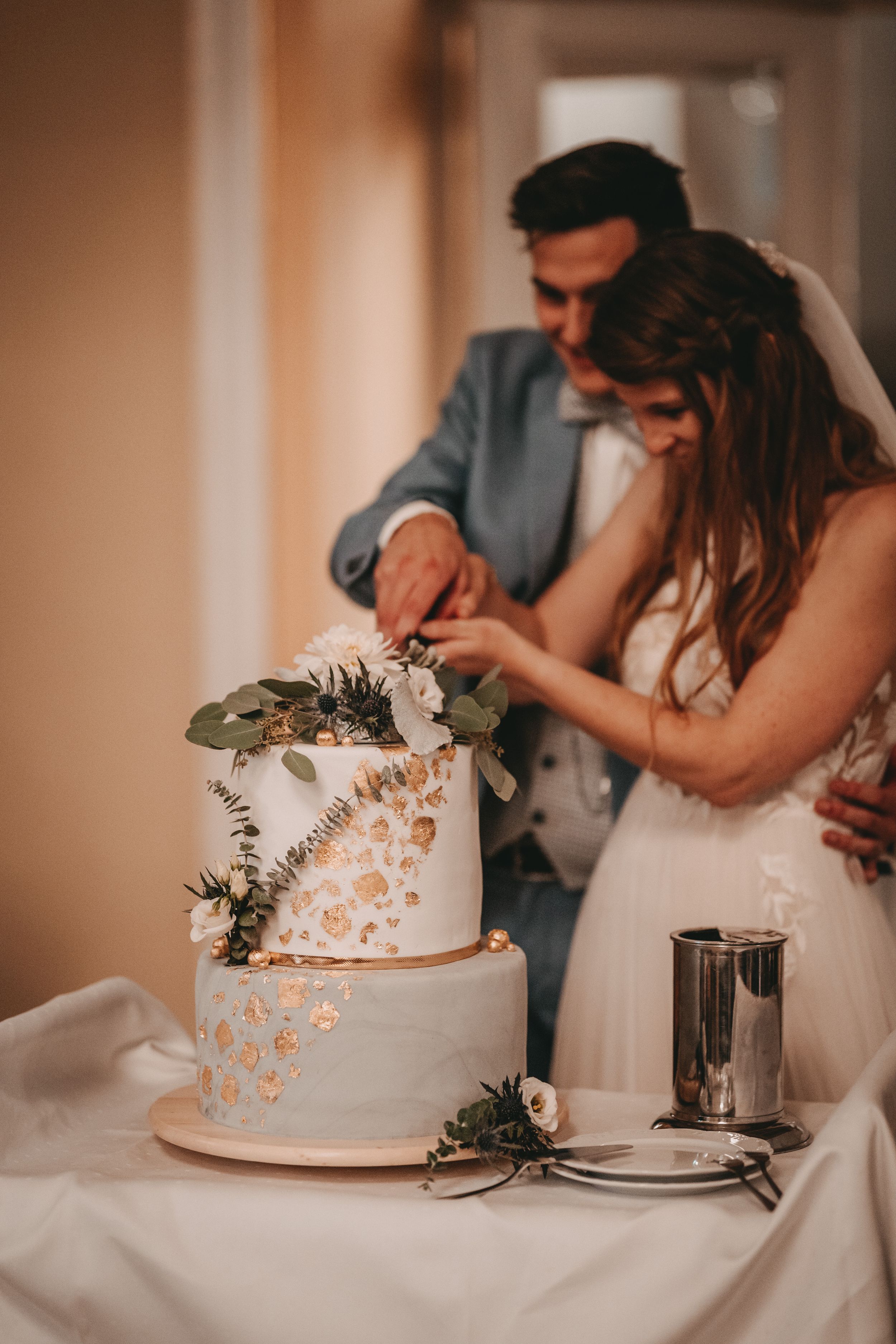 Wedding cake cutting ceremony with couple sharing a sweet moment together.