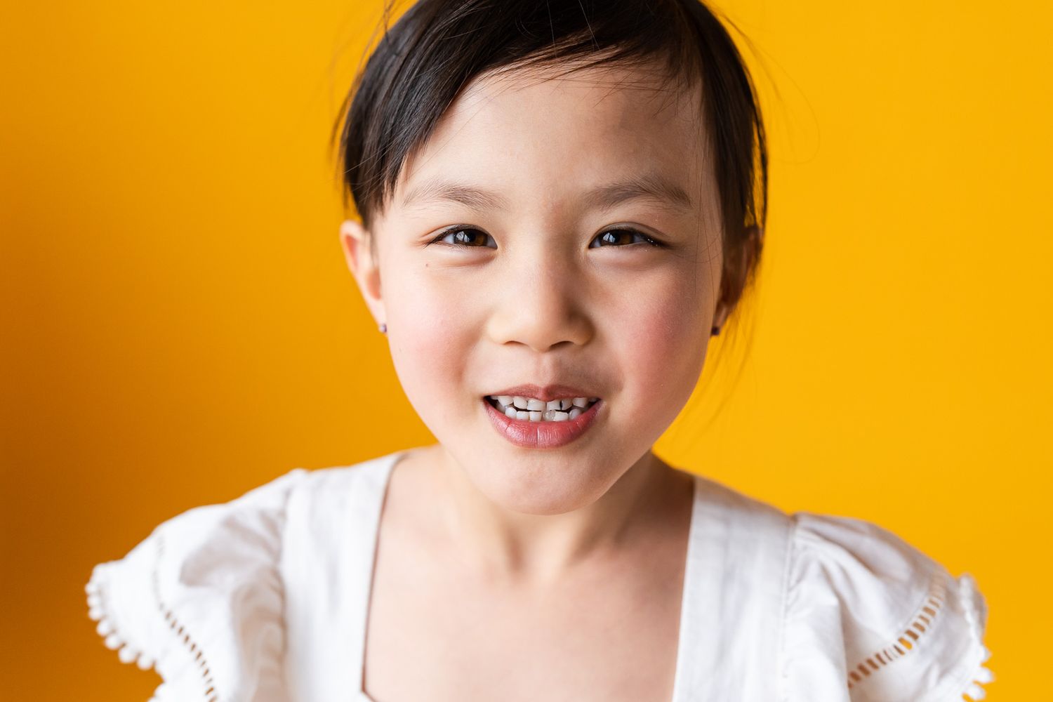 Smiling portrait of a girl in a white dress in Seattle