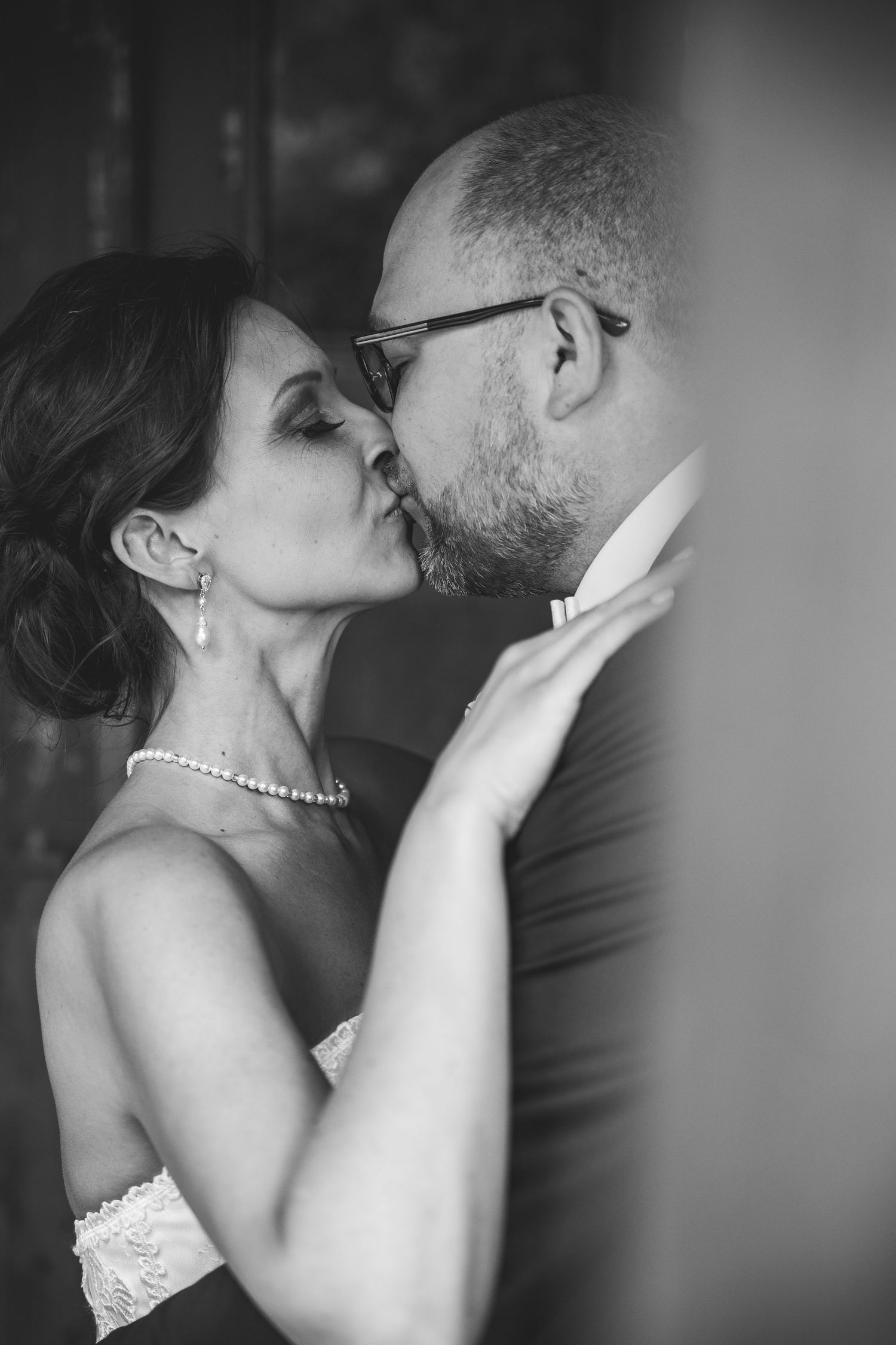 Intimate black and white wedding portraits capturing romantic moments between the couple.