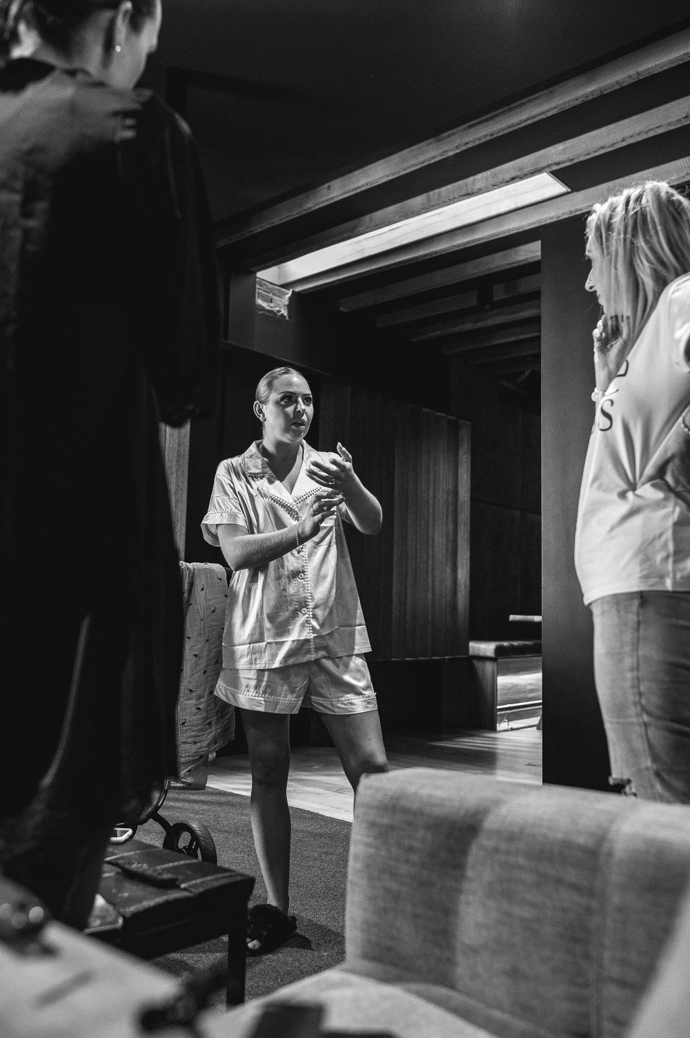 People having conversation in casual setting with basement lighting.