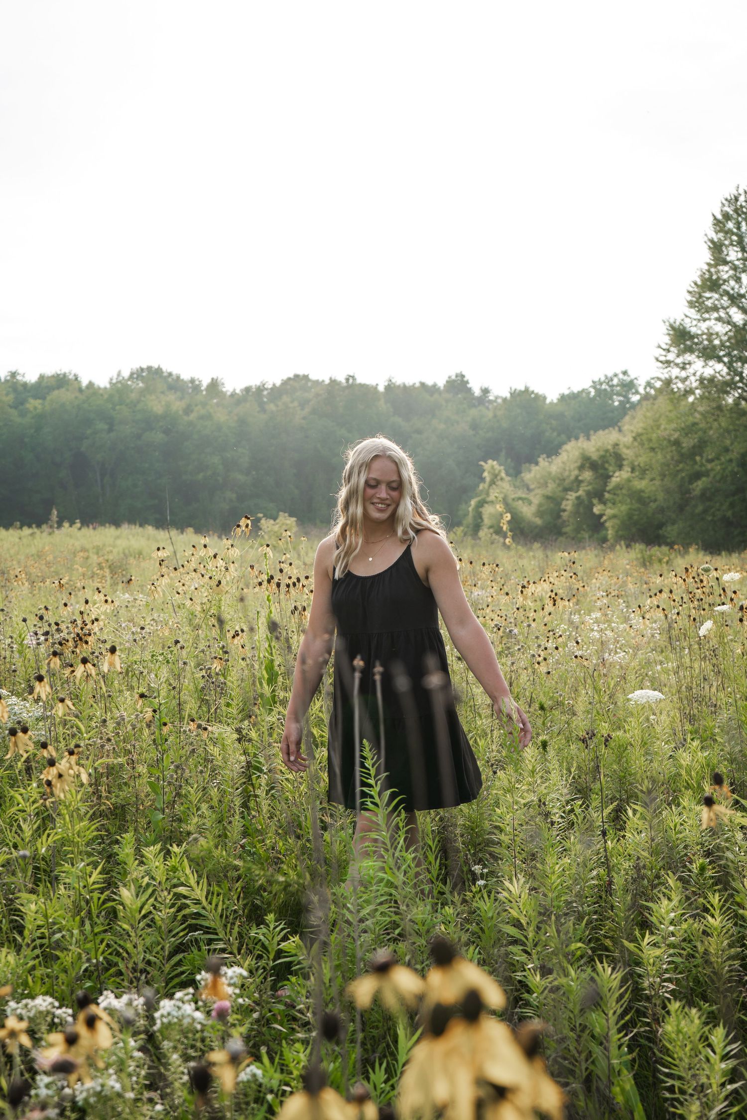 A senior portrait in a flower field