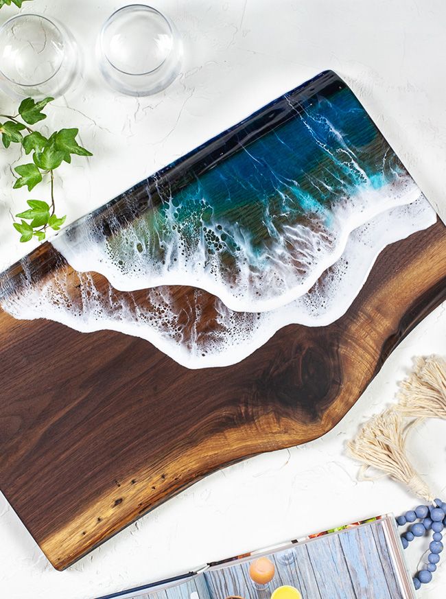 Black walnut serving board with an ocean design made out of resin