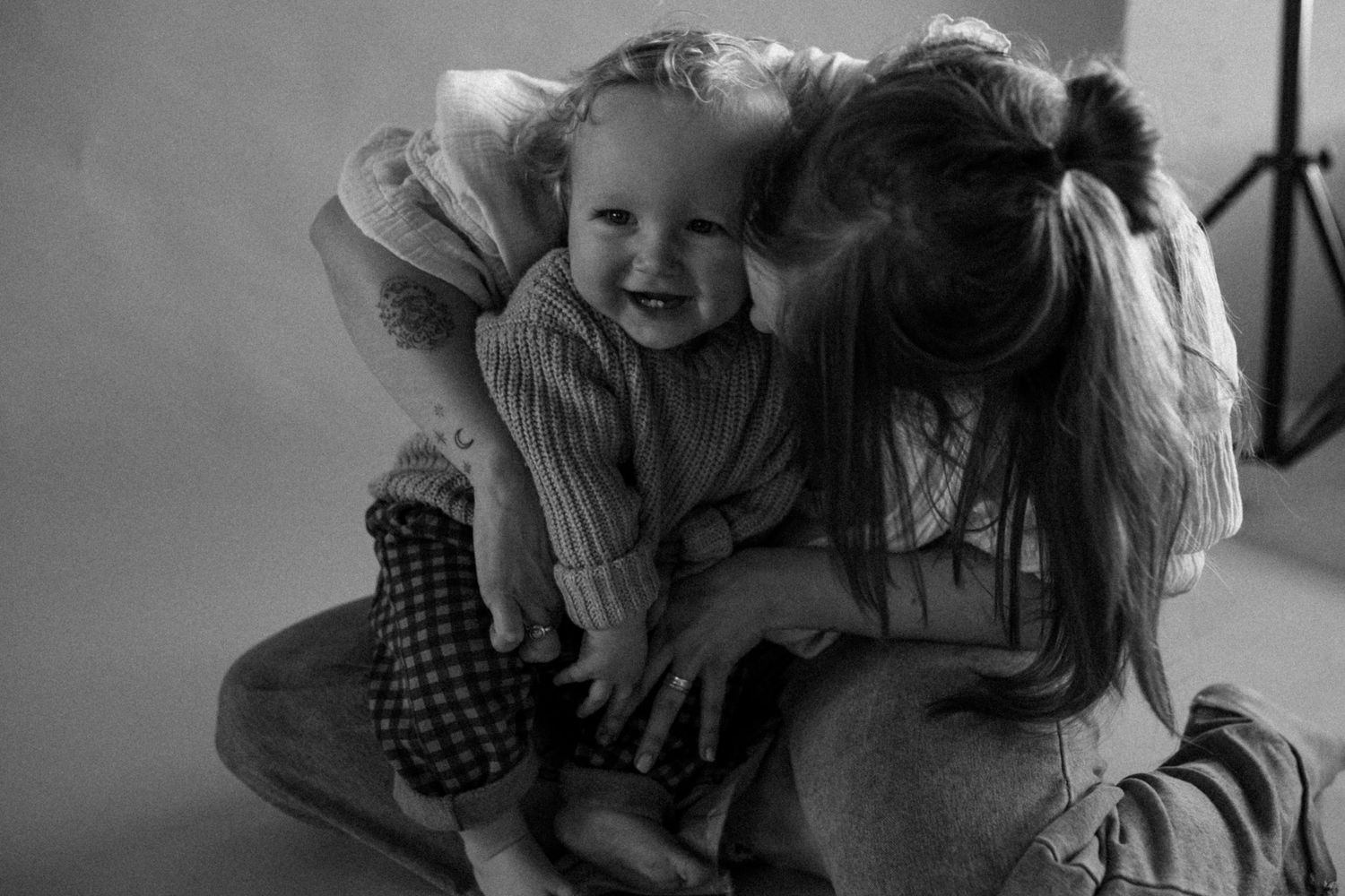 Black and white candid photos capturing joyful laughter and intimate moments.