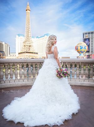 A wedding photo featuring a flowing white dress against the backdrop of the Paris Hotel in Las Vegas.