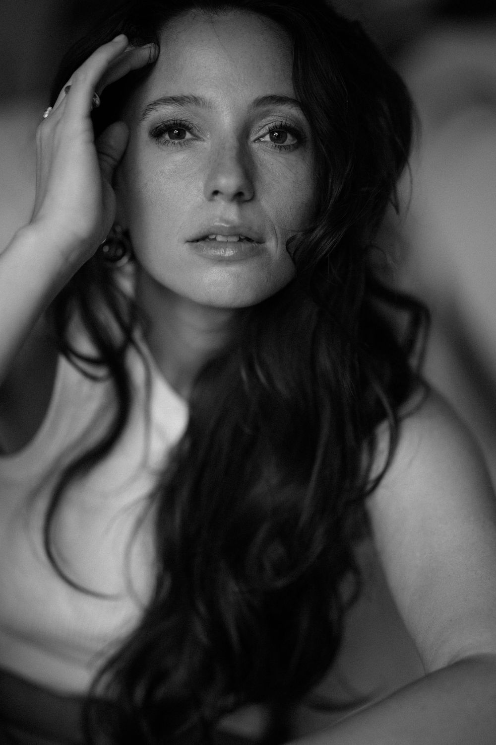 Black and white portrait featuring dramatic lighting and flowing dark hair.
