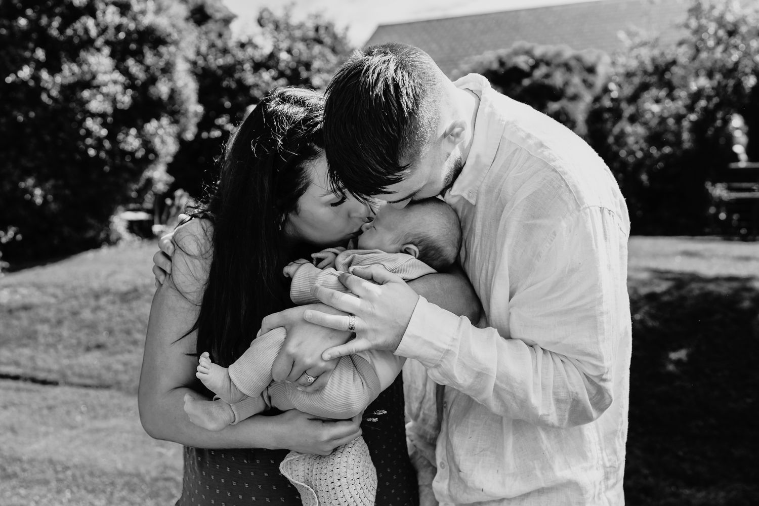 Mammy-and-daddy-kiss-their-newborn-baby
