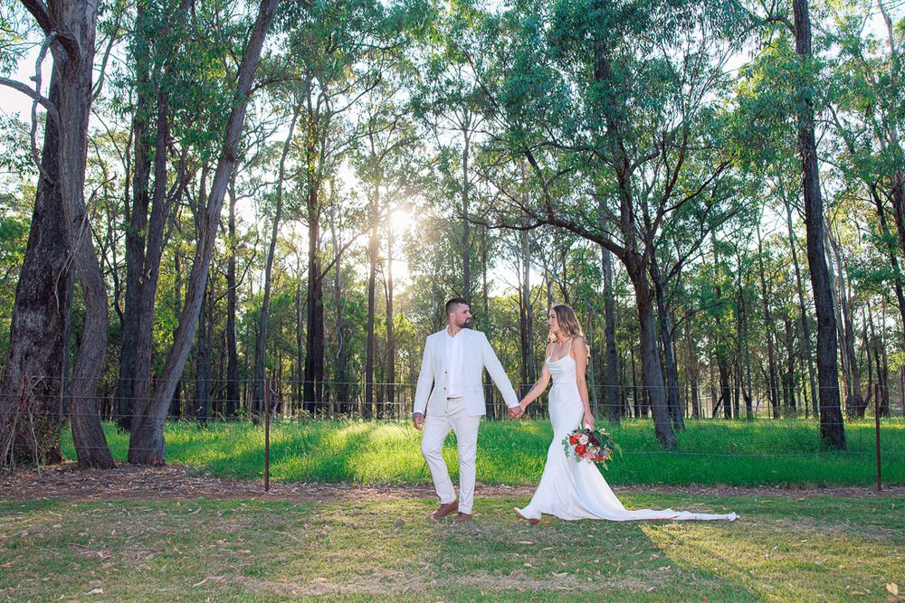 Wedding photography session in a serene wooded area with natural lighting.