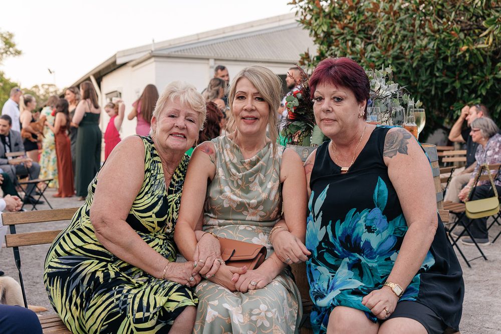 Group enjoys casual outdoor celebration with laughter and smiles.