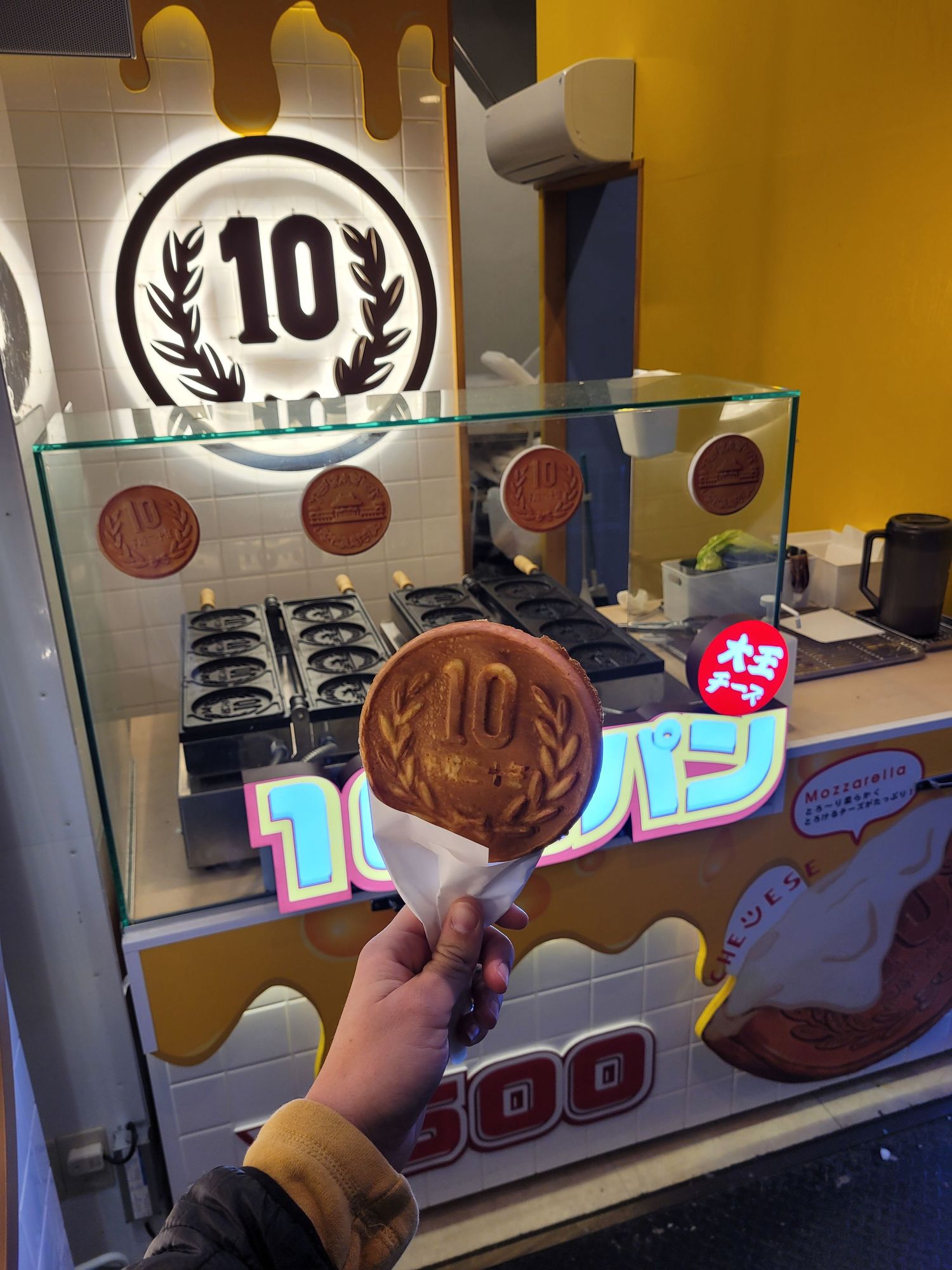 10 yen coin shapped waffel that is sold in japan with cheese filling