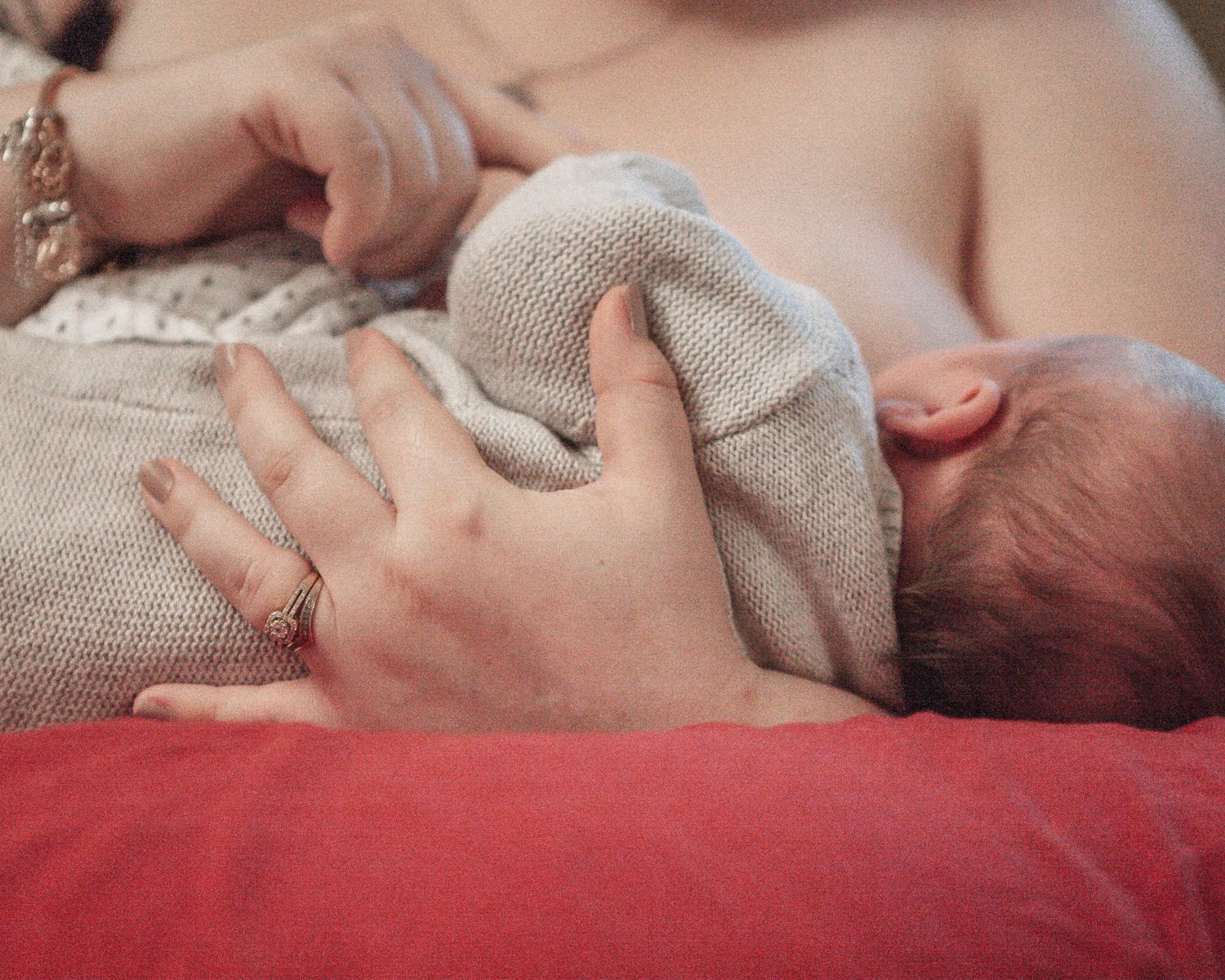 New born at home photo shoot with Cornwall new born photographer mum breast feeding