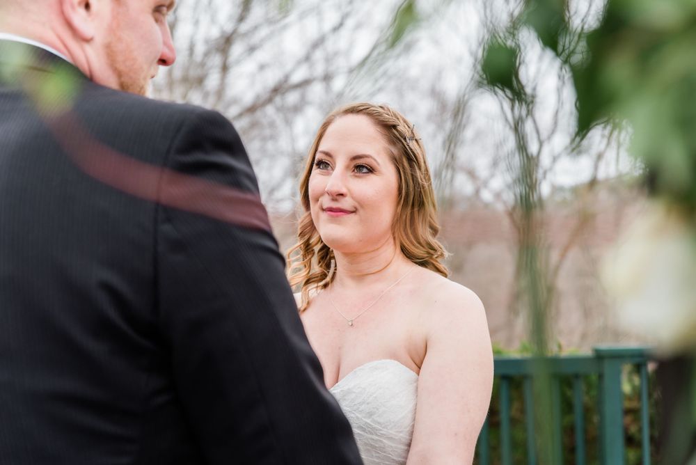 A tender moment during an outdoor wedding ceremony under natural light.