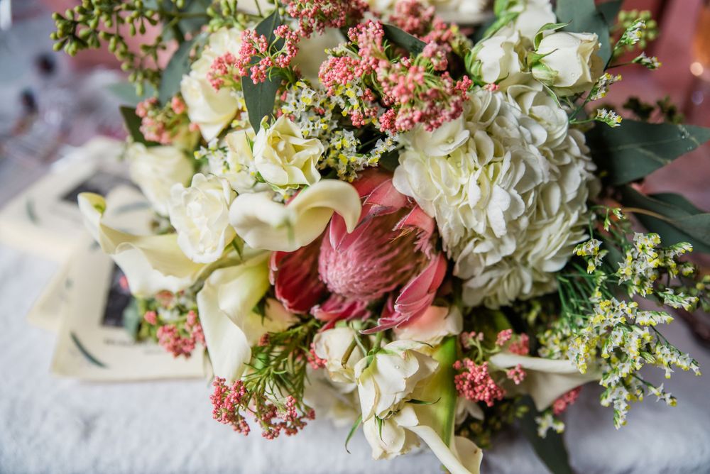 Elegant wedding bouquet with white hydrangeas, pink roses, and delicate greenery.