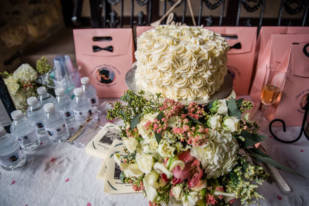 Wedding reception table with white floral arrangements and pink decor elements.