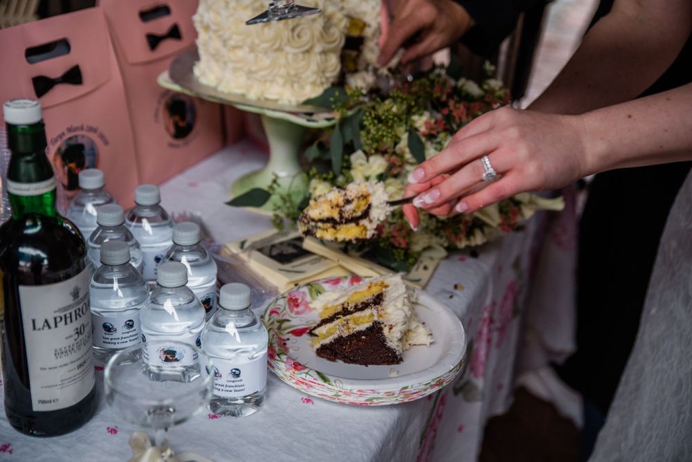 Reception table with wedding cake, champagne glasses, and appetizer plates.