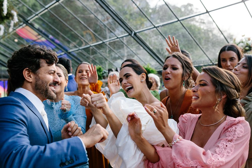 Wedding guests cheering and celebrating with enthusiasm at reception.
