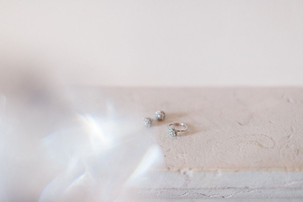 Two delicate wedding rings displayed on a light colored surface.