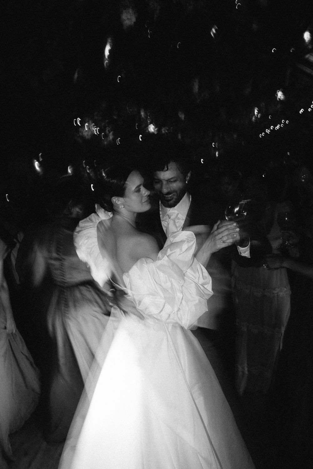 A dreamy black and white photograph of newlyweds sharing an intimate dance.