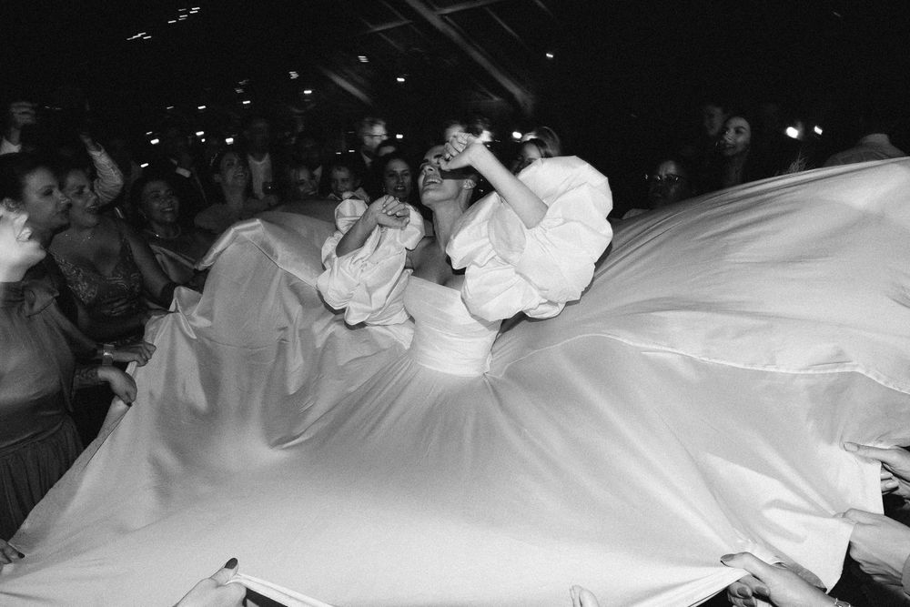 A flowing white wedding dress swirls during an energetic dance.