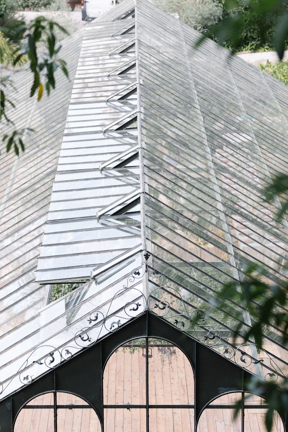 A detailed view of a modern glass and metal conservatory roof structure with geometric patterns.