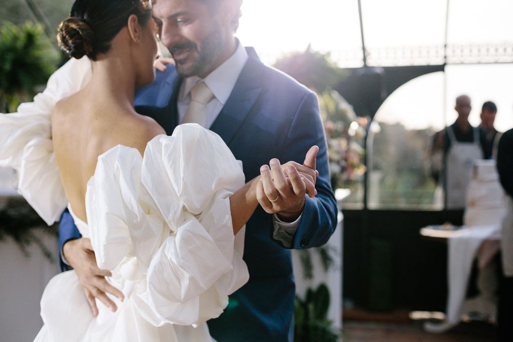 Couple sharing an intimate dance moment in beautiful sunlight.
