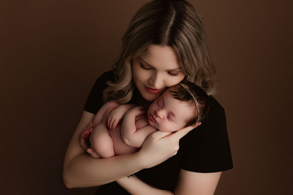 newborn photography calgary - mama holding her baby girl snuggled up
