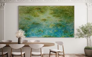 Large abstract water lily painting in green and blue tones mounted in modern dining room.