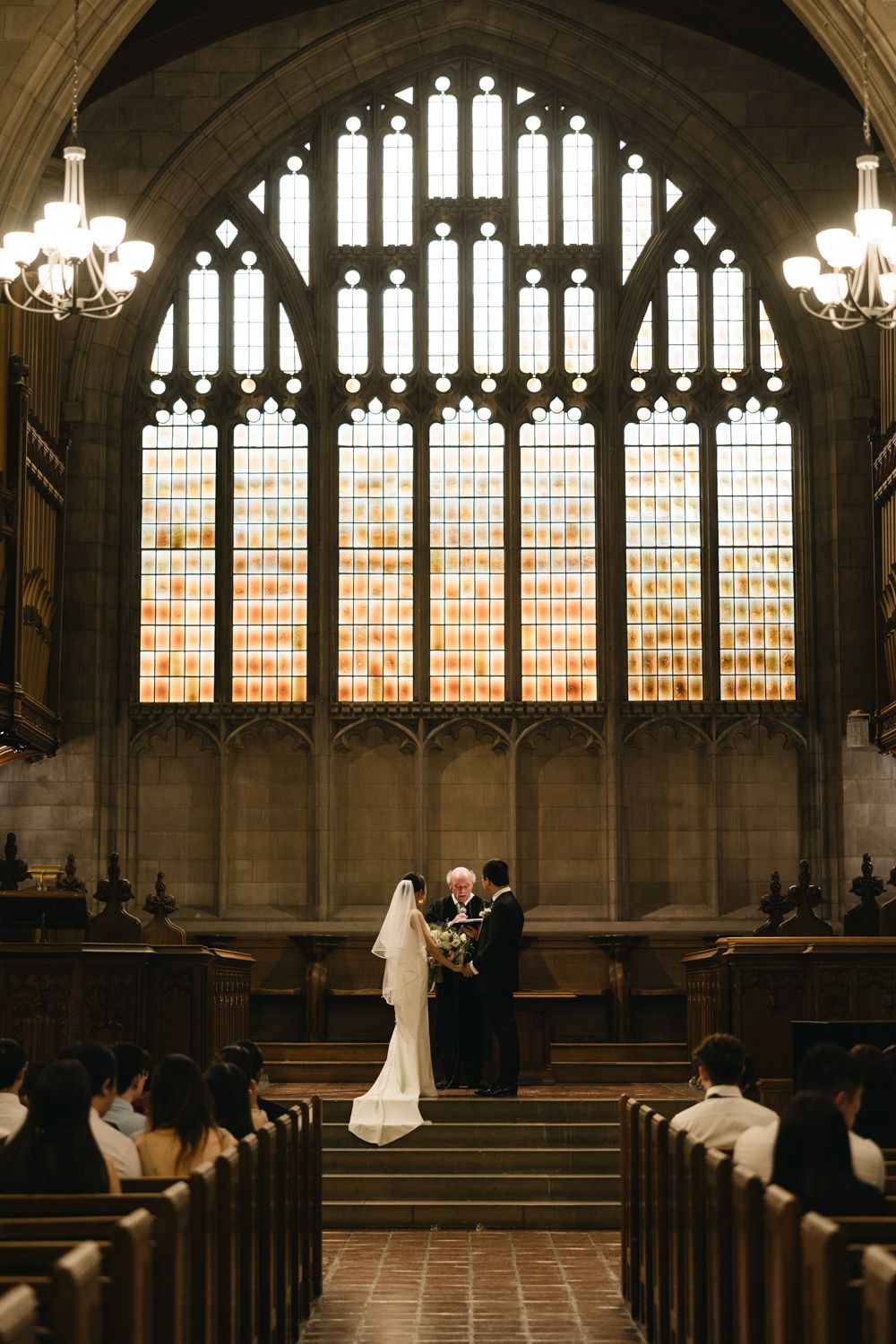 bride and groom holding hand during wedding ceremony captured by wedding photographer