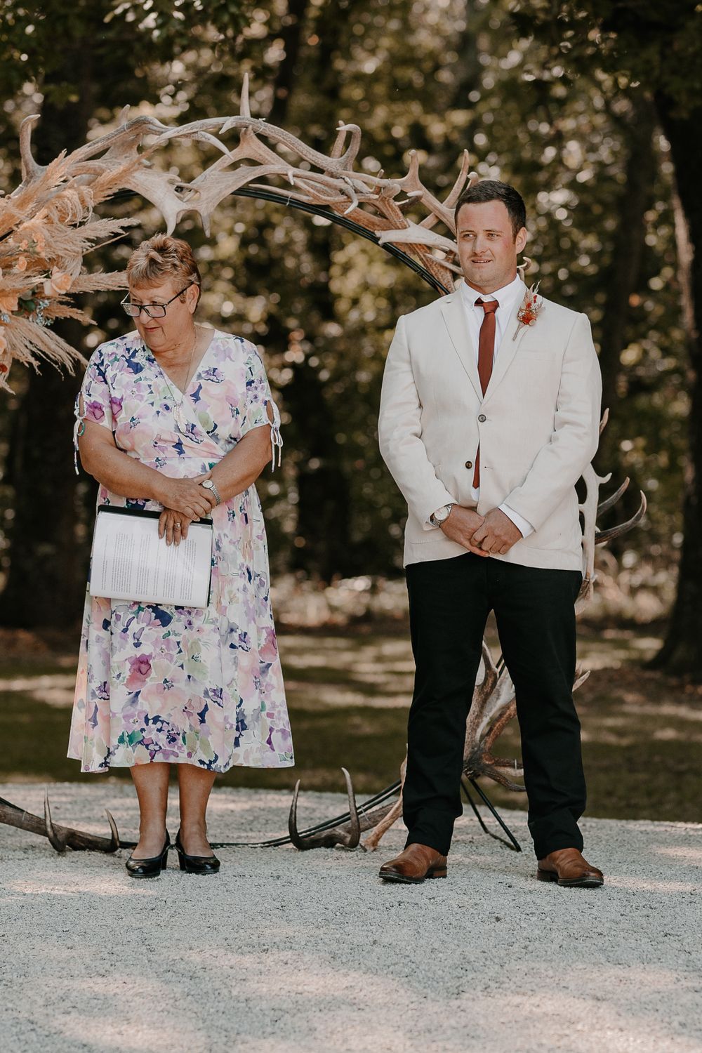 Casual wedding portraits taken outdoors featuring formal attire.