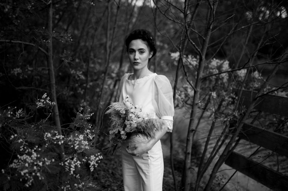 Black and white outdoor portrait session in a natural garden setting.