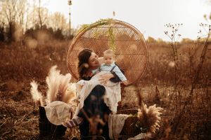 Boho-style family photo session in a Branson field featuring pampas grass and autumn vibes by L. Ballenger Photography.